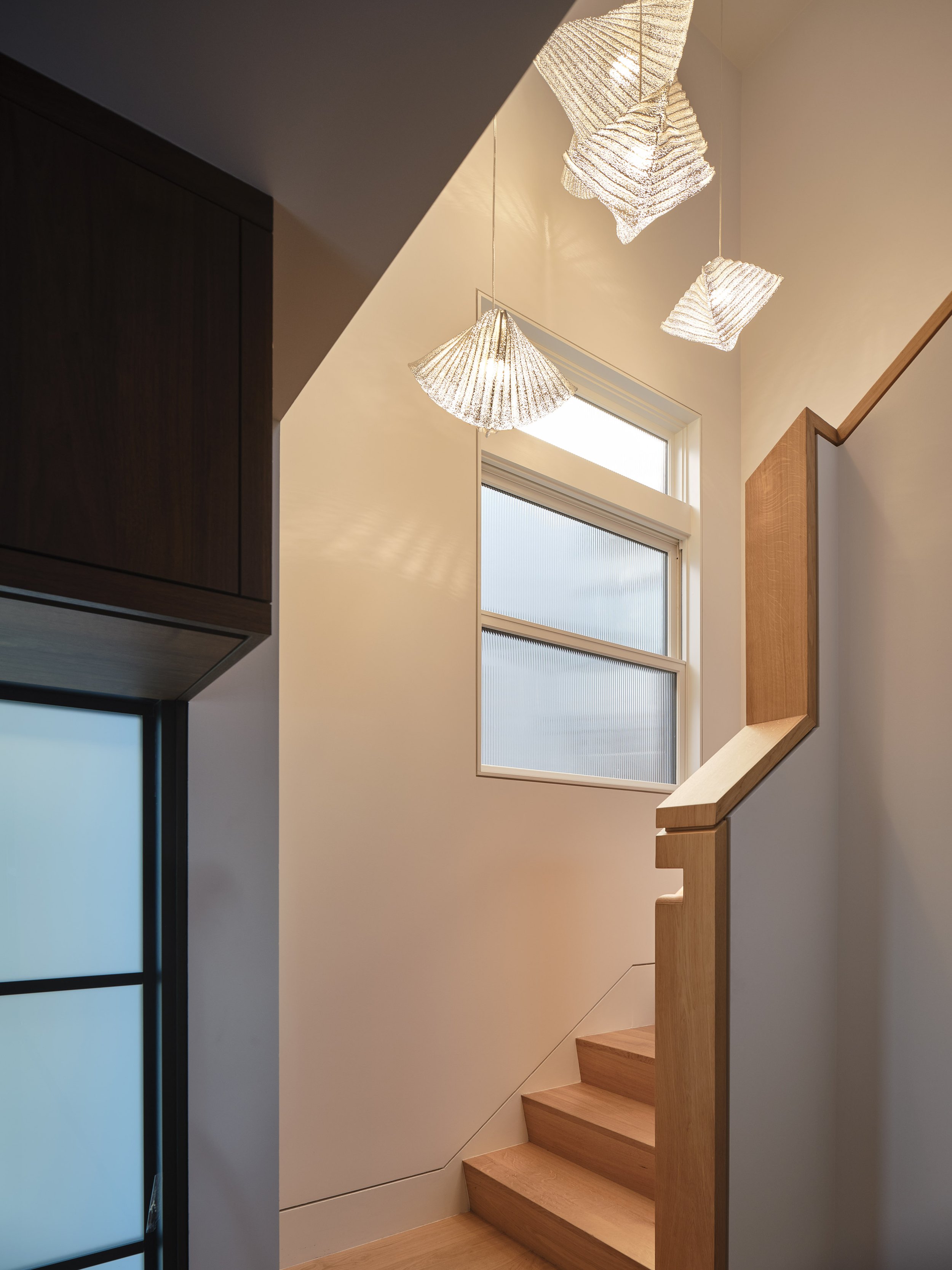 Sculptural wood staircase at Lakeshore Residence
